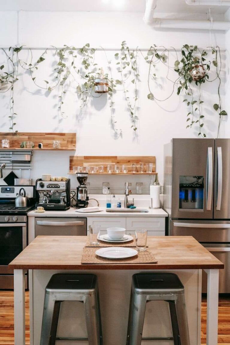 Kitchen and dining area in Scandinavian style located in cozy apartment