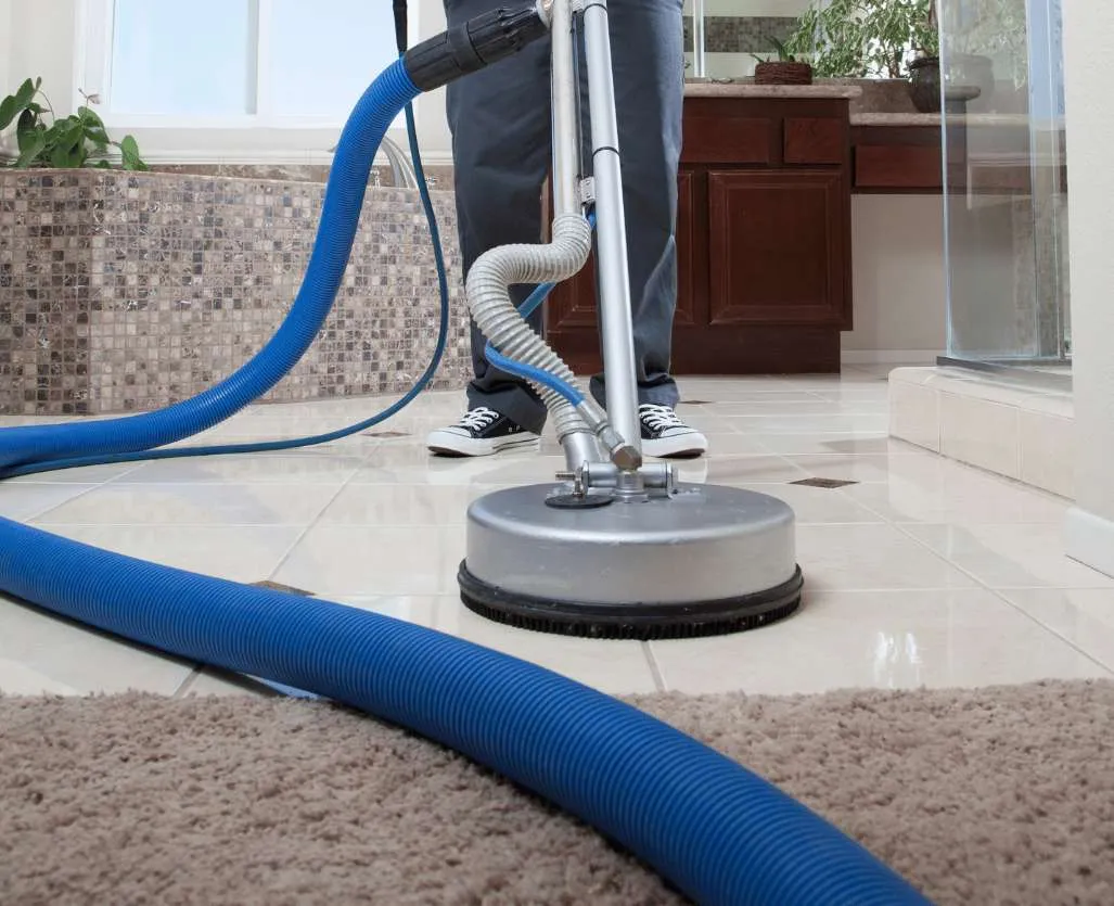 a professional cleaner cleaning bathroom tiles